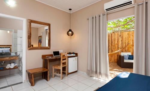 a room with a desk with a computer in it at Pousada Rio Claro in Poconé