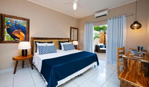 a bedroom with a blue and white bed in a room at Pousada Rio Claro in Poconé