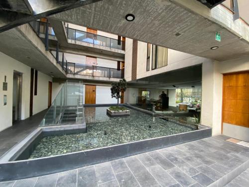 a large room with a pool in the middle of a building at Del Parque Suites in Mexico City