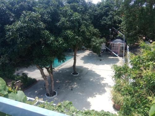 a view of a playground with trees and a slide at Mango Villa Long Hải Beach in Long Hai