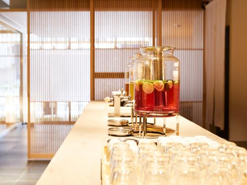 a table with glasses and a blender with cocktails at Agora Kyoto Karasuma in Kyoto