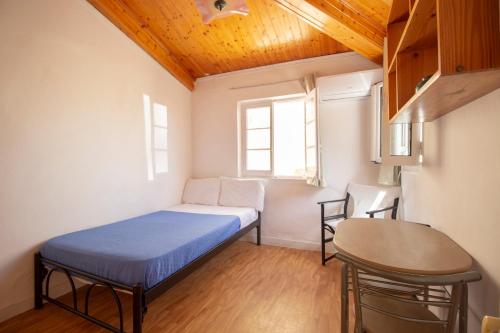A bed or beds in a room at Studio attic in Corfu Town centre