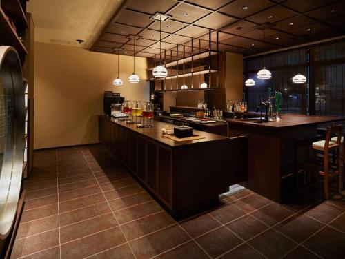 a large kitchen with a bar in a restaurant at Agora Kyoto Shijo in Kyoto