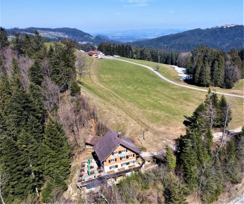an aerial view of a house in the middle of a field at Gasthaus Moosegg in Lochau