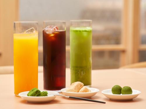 a table with three glasses of different types of juice at Agora Kyoto Shijo in Kyoto