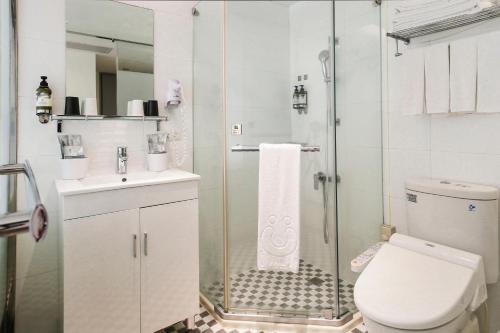 a bathroom with a shower and a toilet and a sink at CityInn Hotel Taipei Station Branch III in Taipei