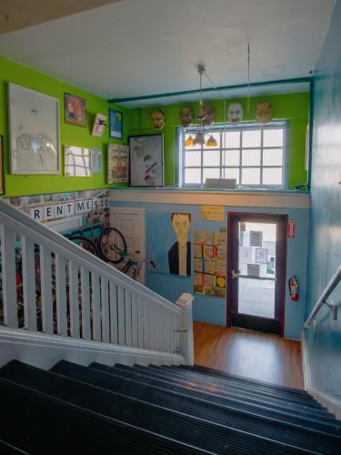 a room with a staircase and a stair case at Lucky D's Youth and Traveler's Hostel in San Diego