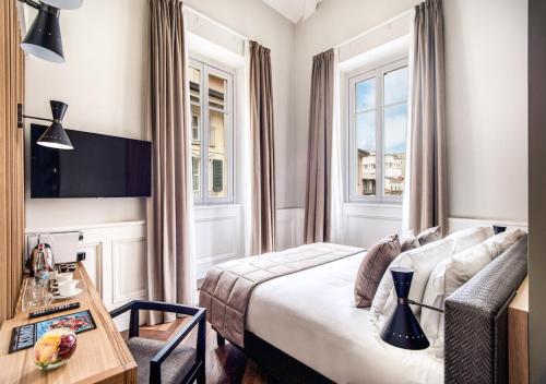 a hotel room with a bed and a table at DBH – Boutique Hotel Lake Como in Como