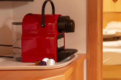 a red coffee maker sitting on top of a shelf at Four Seasons Lodge in Lackenhof