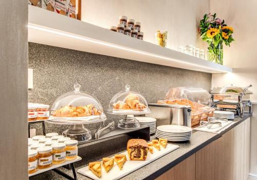 a buffet line with dishes and food on display at DBH – Boutique Hotel Lake Como in Como