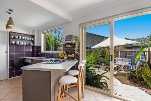 an open kitchen with a counter and a patio at Sea Haven - Lennox Head in Lennox Head