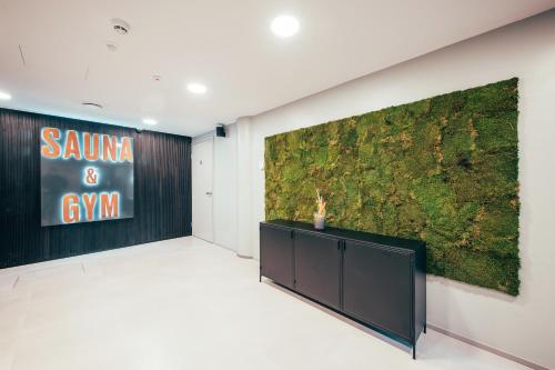 a room with a large painting on the wall at The Folks Hotel Konepaja in Helsinki