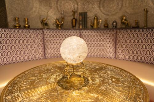 a gold clock with a glass dome on top of it at Hotel Zed Tofino in Tofino