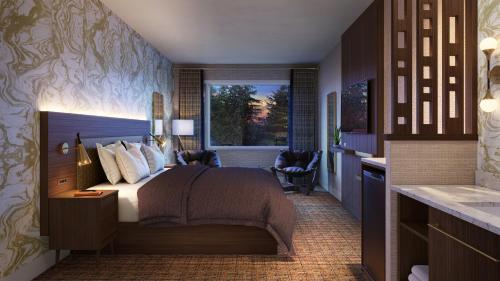 a hotel room with a bed and a window at Hotel Zed Tofino in Tofino