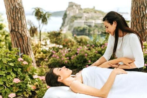 a woman getting a massage from a therapist at Villa Livia in Ischia