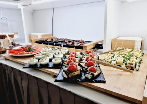 a buffet with various types of food on display at Kalinifta Rooms Apartment in Torre Lapillo