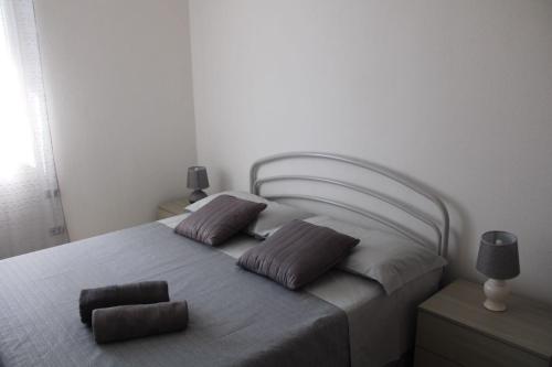 a bedroom with a bed with two pillows on it at Villa Cedrino Orosei in Orosei