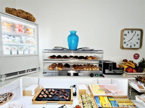an open refrigerator filled with lots of different types of food at Kalinifta Rooms Apartment in Torre Lapillo