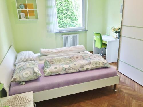 a small bedroom with a bed and a desk at Bozen - Gries in Bolzano