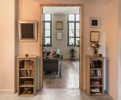a living room with a door open to a living room at Hotel Galla Placidia in Narbonne