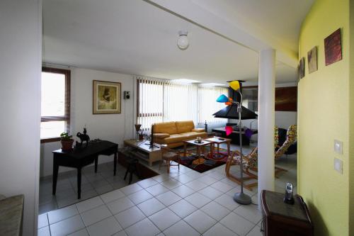 a living room with a couch and a table at Gîte comme à la maison -12 pers- La Cabiote in Les Piards