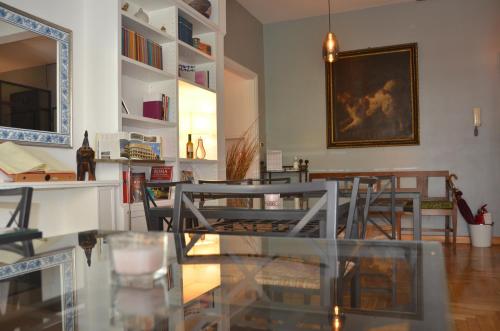 a dining room with tables and chairs and a painting on the wall at Sweet Home Parioli in Rome