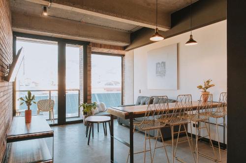 a dining room with a table and chairs at Hotel 3450 Living Lofts in Medellín