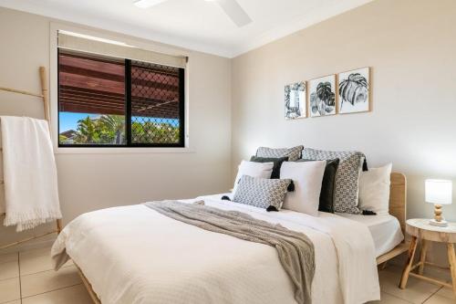 a bedroom with a bed and a window at Indah - Lennox Head in Lennox Head