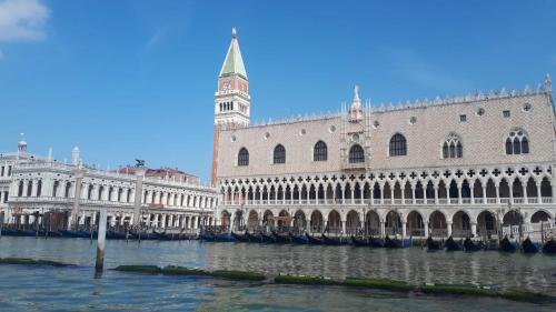 a large building with a clock tower next to the water at Hotel Terramare in Lido di Jesolo