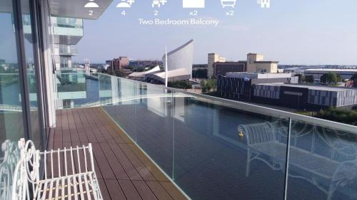 a balcony with a swimming pool on top of a building at Media City Salford Quays in Manchester