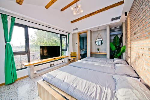 a bedroom with a large bed and a large window at Hidden in the World (Winter Olympic Town) - Stay Together in Liubinbu