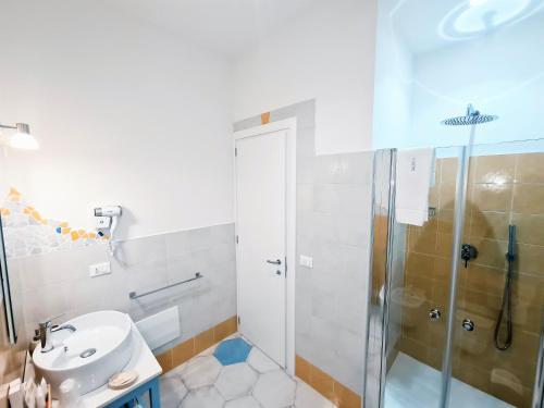 a bathroom with a shower and a sink at Kalinifta Rooms Apartment in Torre Lapillo