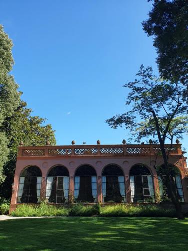 a large brick building with a tree in the grass at Villa Bottini La Limonaia in Robecco dʼOglio