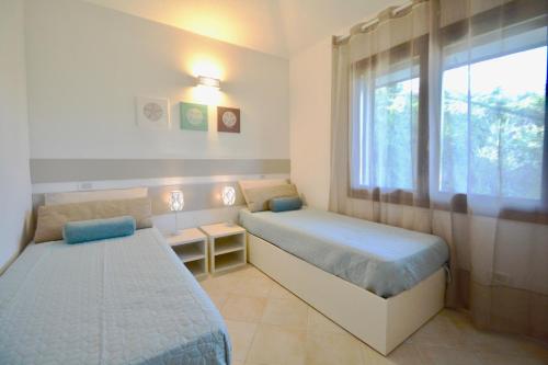 Postel nebo postele na pokoji v ubytování Case Sul Mare Residenze Di Bes