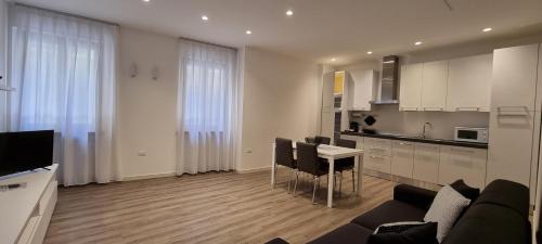 a kitchen and living room with a couch and a table at RivAppartamenti in Riva del Garda