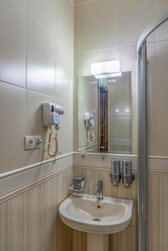 a bathroom with a sink and a mirror at Feder Boutique Hotel in Lviv