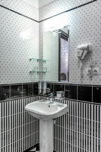 a bathroom with a sink and a mirror at Feder Boutique Hotel in Lviv