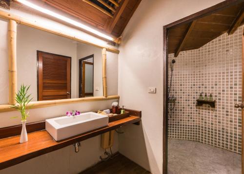 a bathroom with a sink and a shower at River Kwai Resotel in Sai Yok