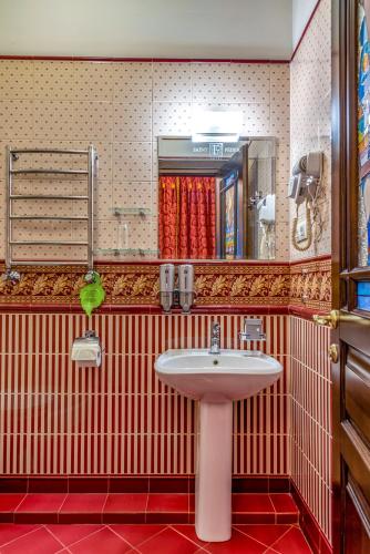a bathroom with a sink and a mirror at Feder Boutique Hotel in Lviv