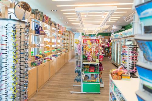 a store aisle with shelves of toys and other items at The Waters Khao Lak by Katathani - SHA Extra Plus in Khao Lak
