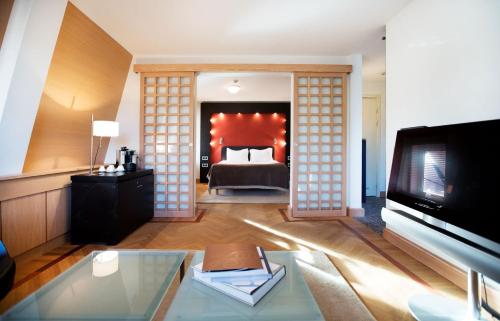 - un salon avec un lit et une télévision dans l'établissement Hotel Lundia, à Lund