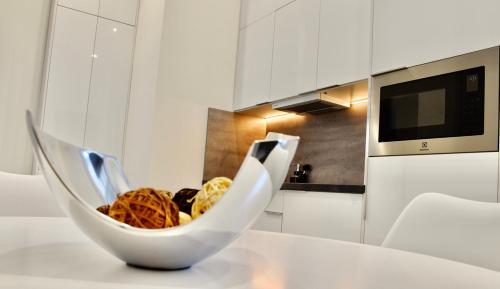 a bowl of food sitting on a table in a kitchen at Bogáthy Kúria Business Apartments in Nyírbogát