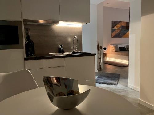 a kitchen with a table with a bowl on it at Bogáthy Kúria Business Apartments in Nyírbogát