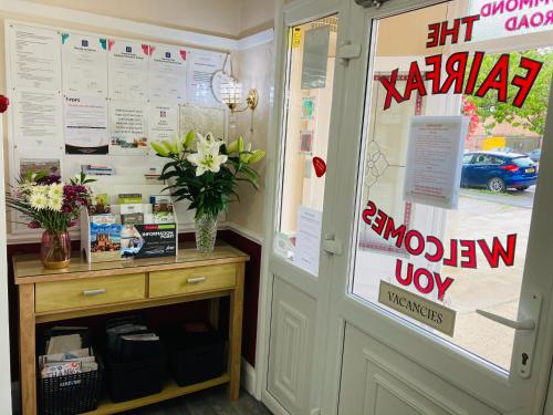a door to a shop with a vase of flowers at Fairfax in Skegness