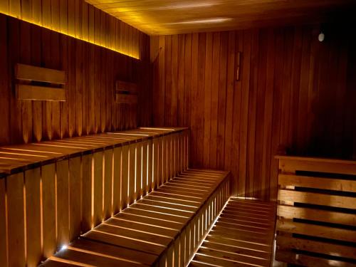 a row of empty wooden shelves in a sauna at Spa Residence Carbona Apartman 104 in Hévíz