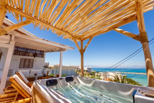 a hot tub on a house with a view of the ocean at The Roof-Top in Megalochori