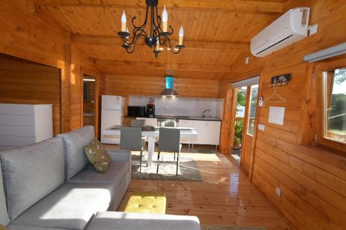 a living room with a couch and a kitchen at Moinho da Capela in Campo Maior