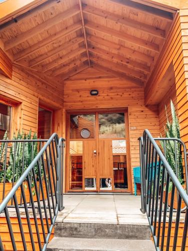 a wooden house with a staircase leading to the front door at Porto Pim Bay in Horta