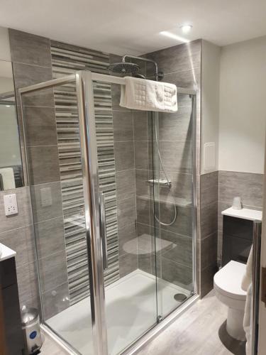 a bathroom with a shower and a toilet at Sunninghill Hotel in Elgin