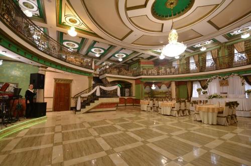 a large room with tables and chairs in a building at MishyN-City Hotel in Dobrovlyany